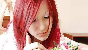 Delicious red haired miss is looking at these flowers before sex